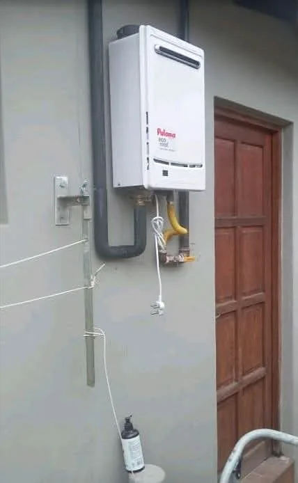 Gas water heater mounted on an exterior wall